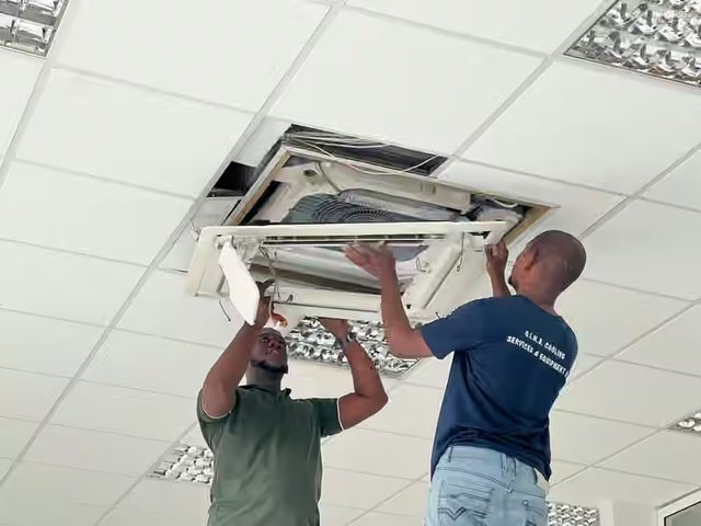 G.I.M.S. technicians fitting a ceiling cassette in an office